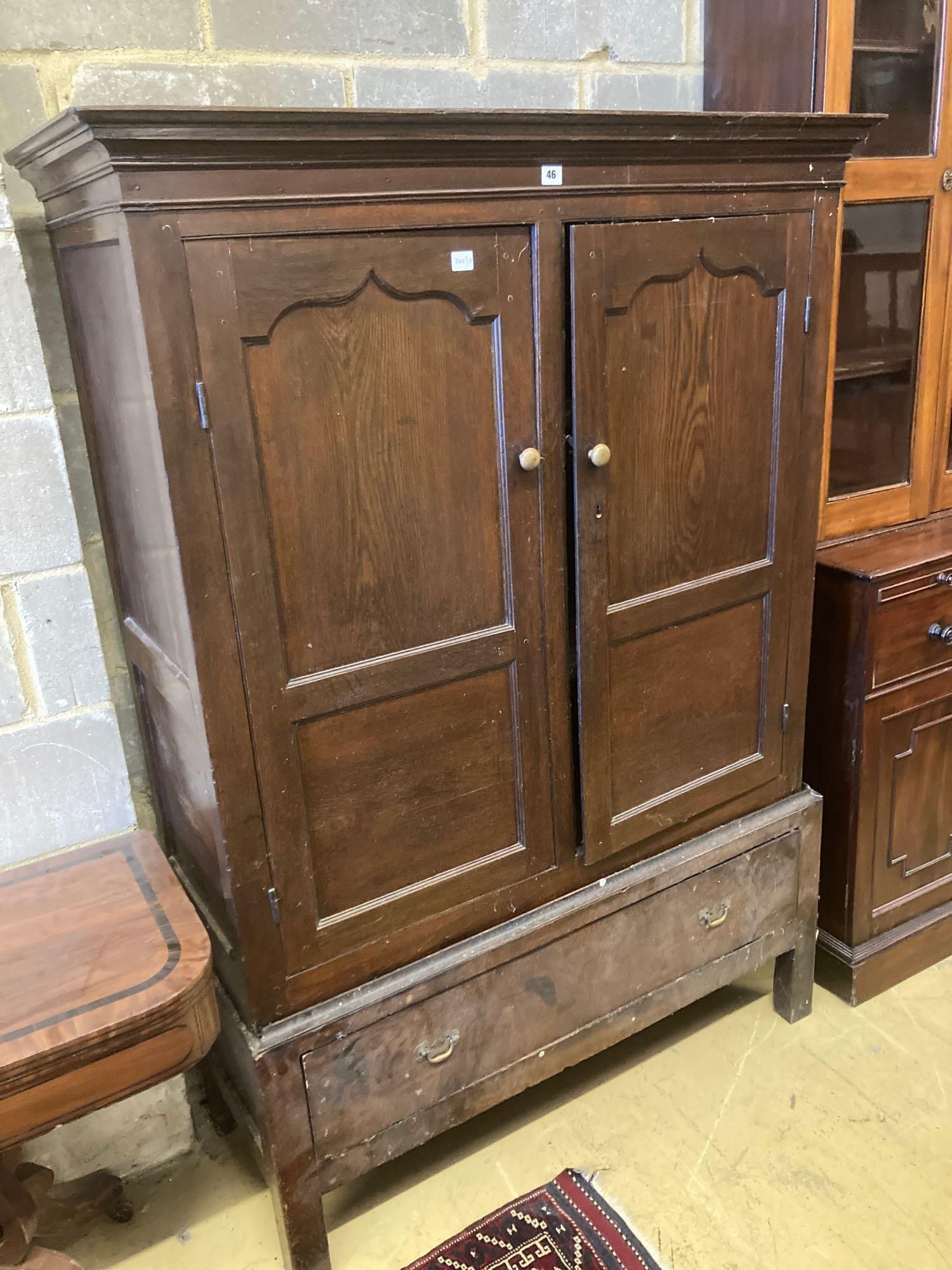 An 18th century oak press cupboard with base drawer, width 120cm height 169cm